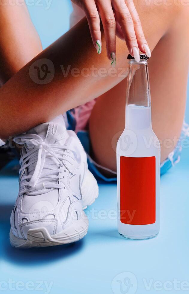 Woman relaxing with refreshing drink after workout session photo