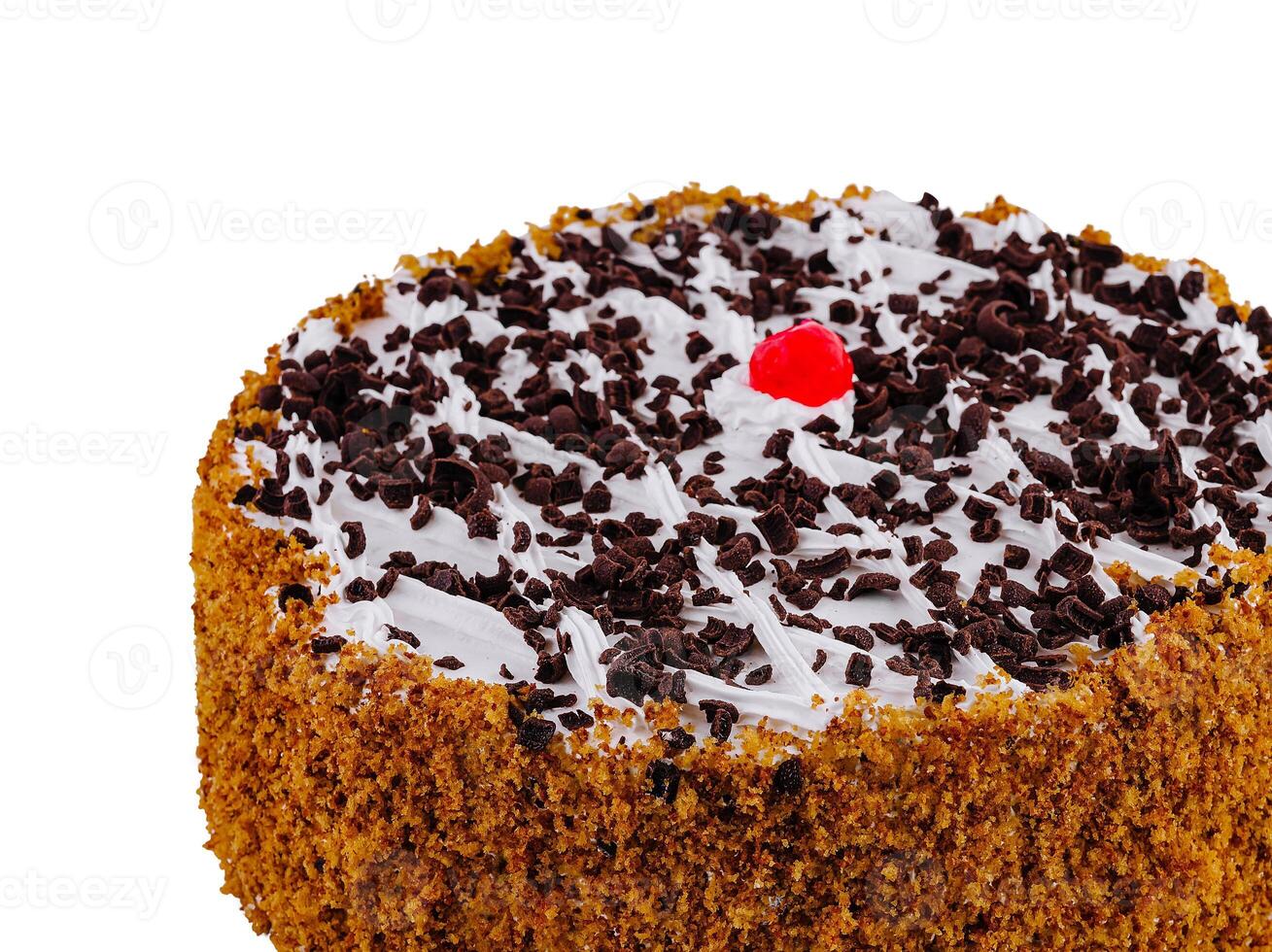 Delicious round chocolate cake with chocolate sprinkles and cherry on top isolated on white background photo