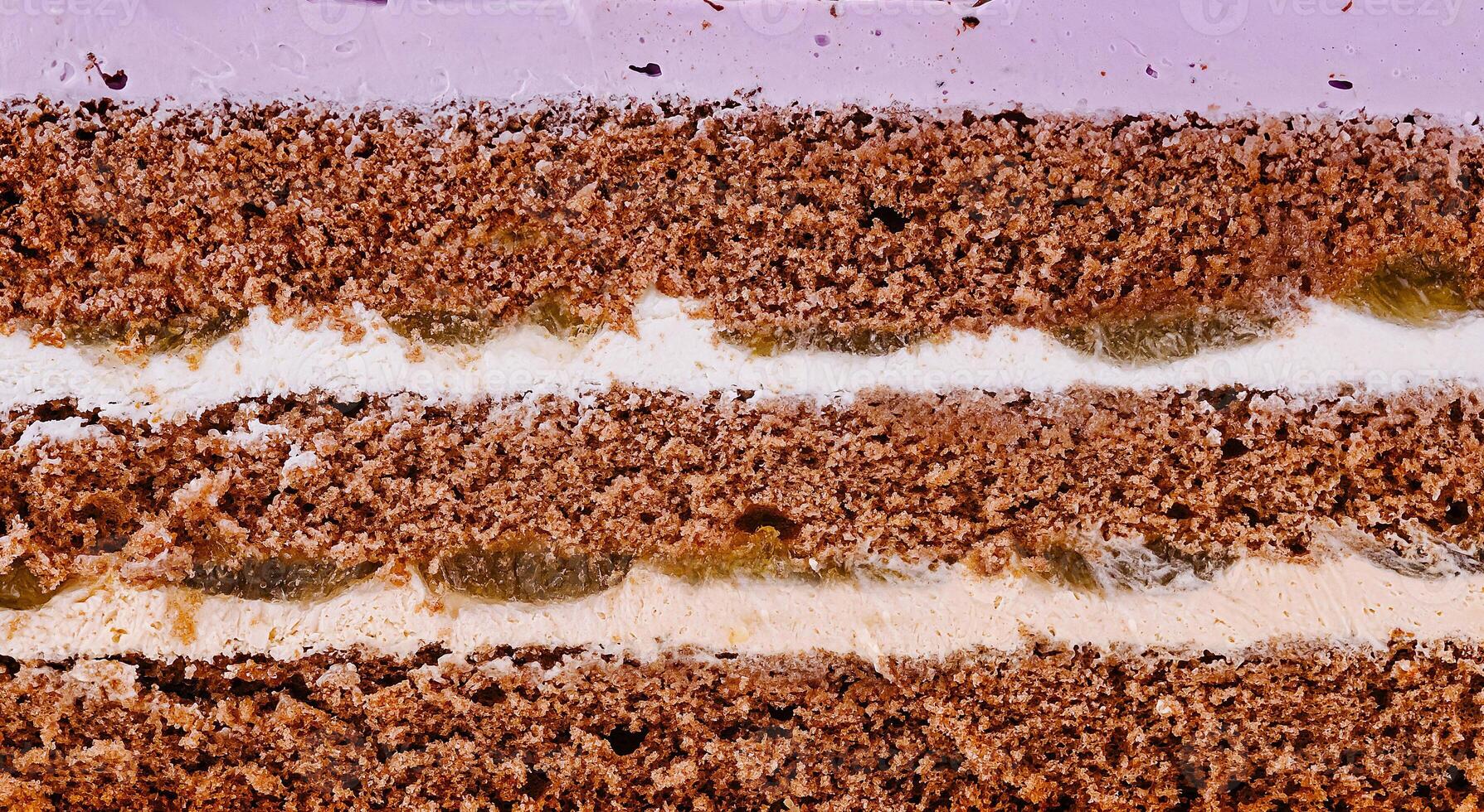 Delicious cake layers showing filling and frosting close up photo