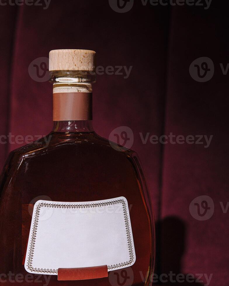 Premium bottle of brandy on elegant background photo