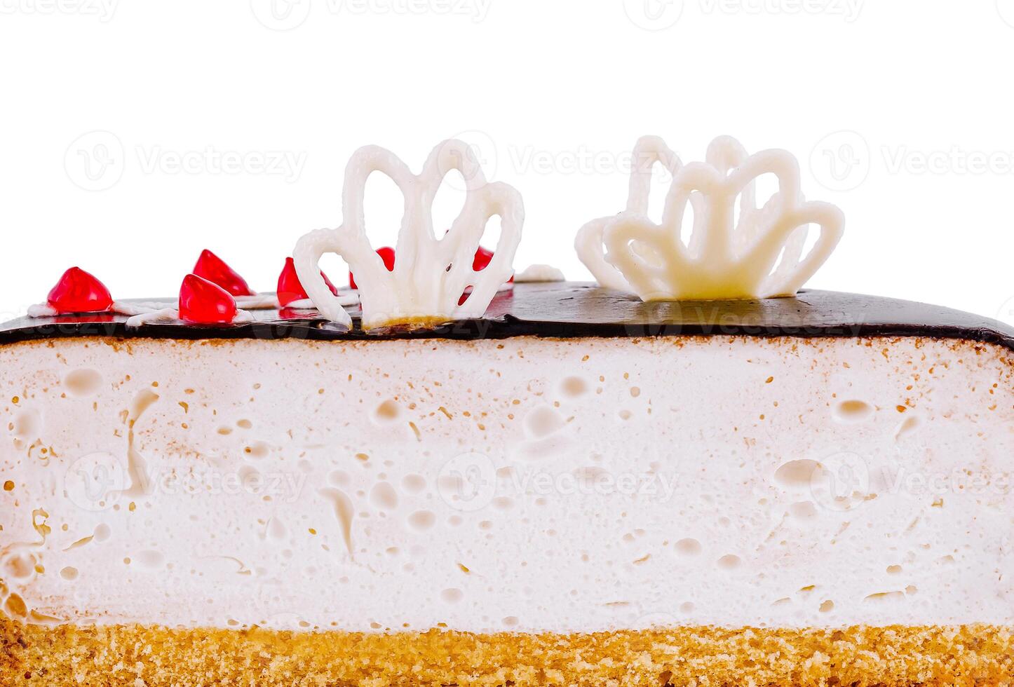 Delicious cake with white chocolate decorations is showing its layers photo