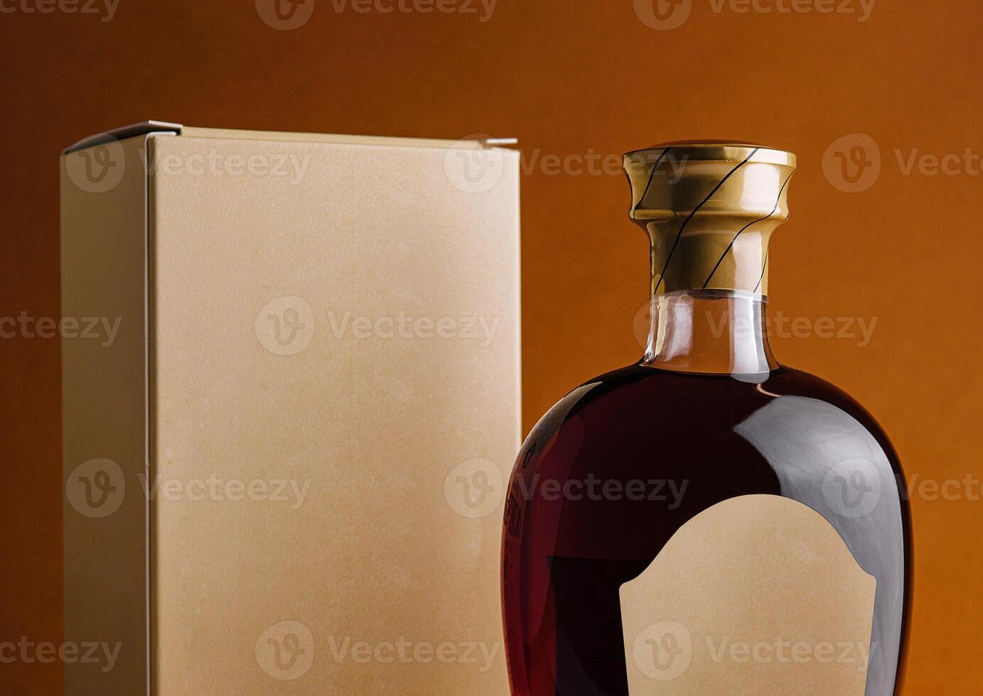 Bottle of alcohol with blank label and cardboard packaging standing on orange background photo