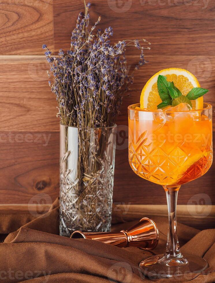 Aperol spritz cocktail is standing on the bar counter and waiting bartender photo