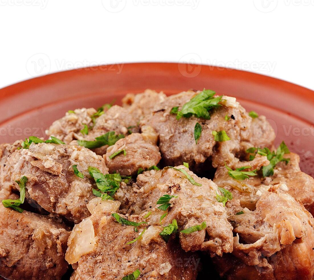 Stewed pork meat with herbs and spices on a plate photo