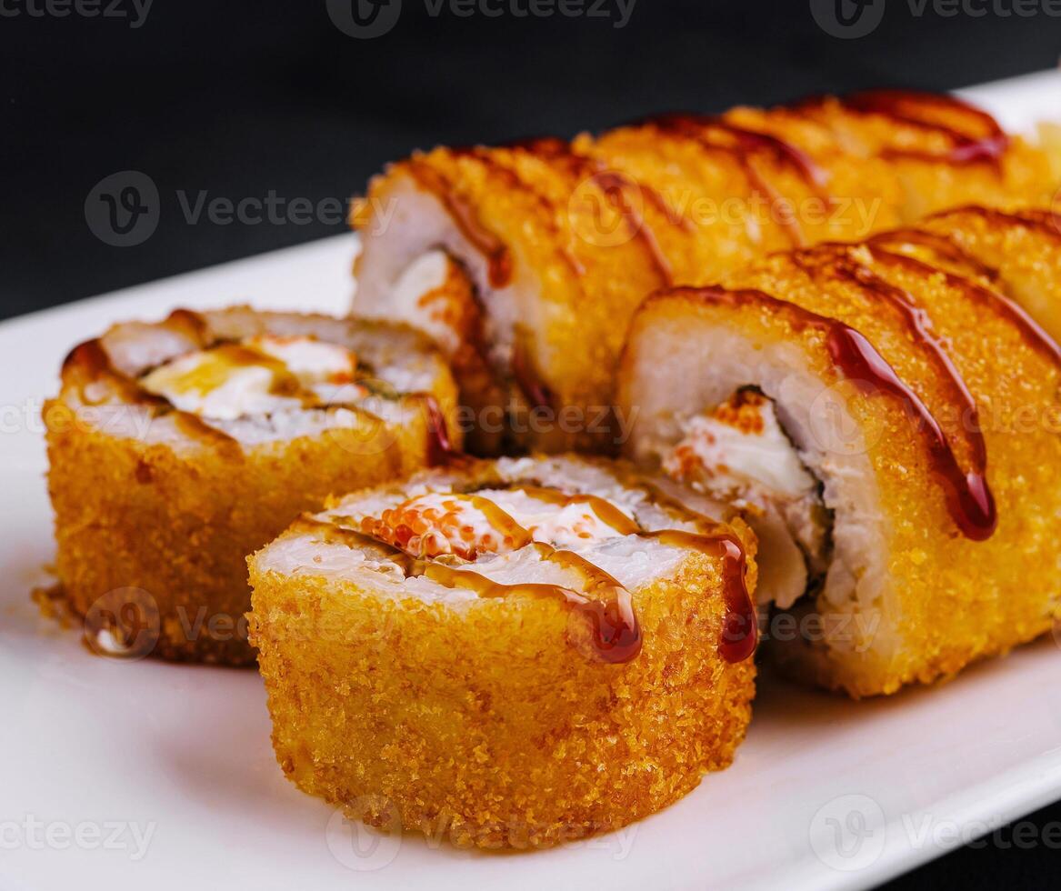 Delicious tempura maki sushi rolls being served on white plate photo