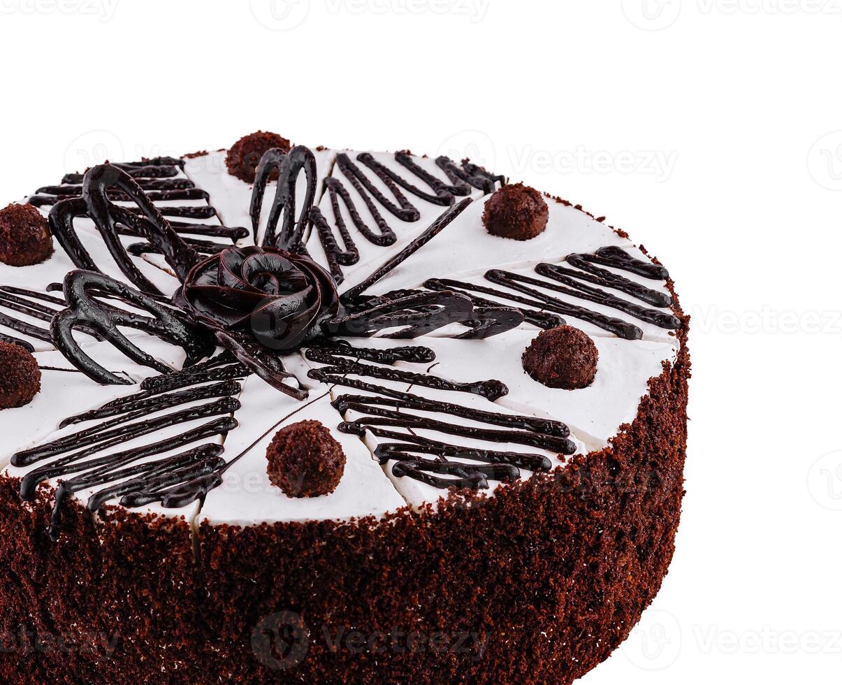 Chocolate cake with white icing and chocolate decorations, isolated on white photo