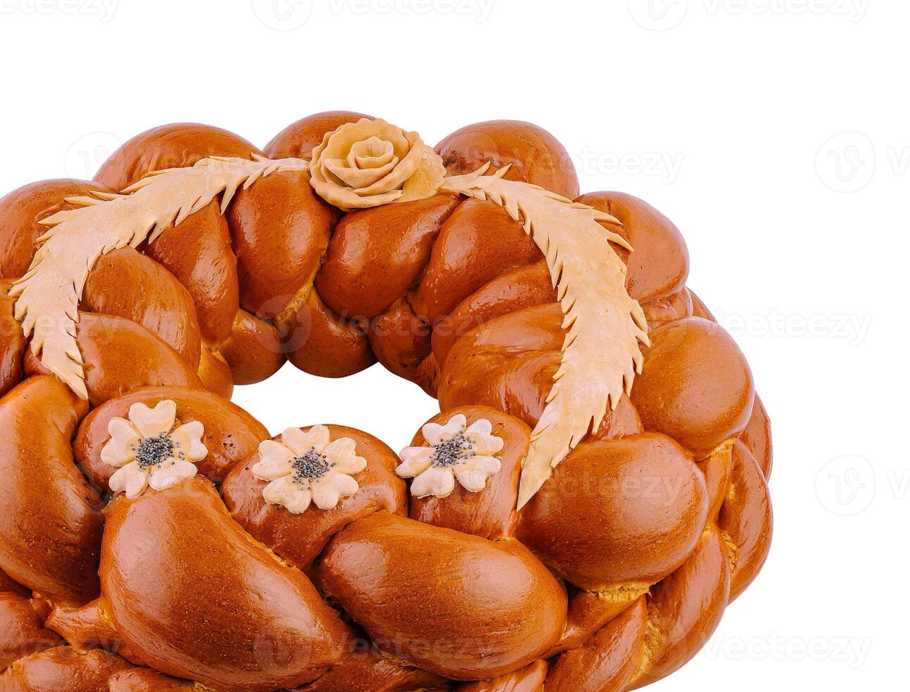 Round loaf of bread decorated with flowers and wheat for a celebration photo