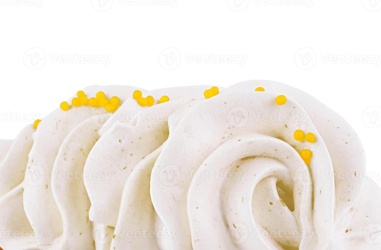 Delicious white creamy topping with yellow sprinkles closeup photo