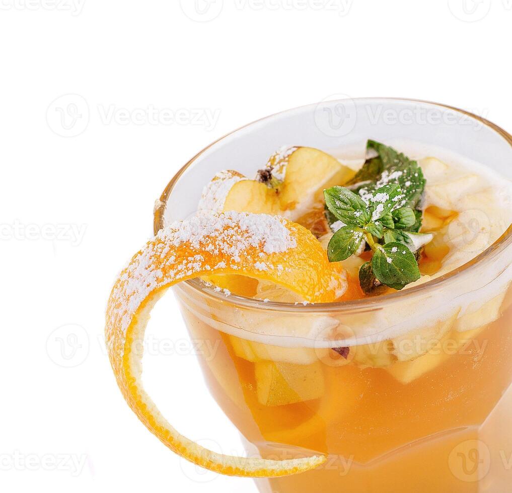 Cocktail with apple slices, orange peel and mint decorated with powdered sugar photo