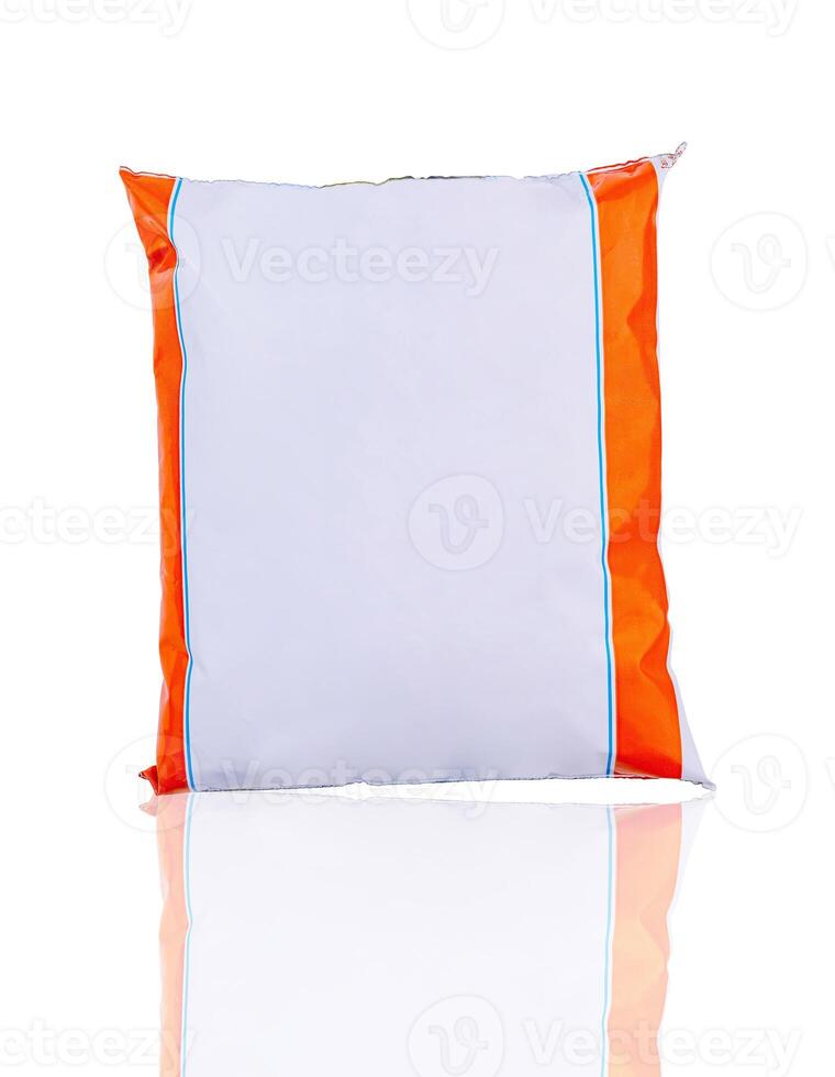 Foil food package standing up and reflecting on a white background photo