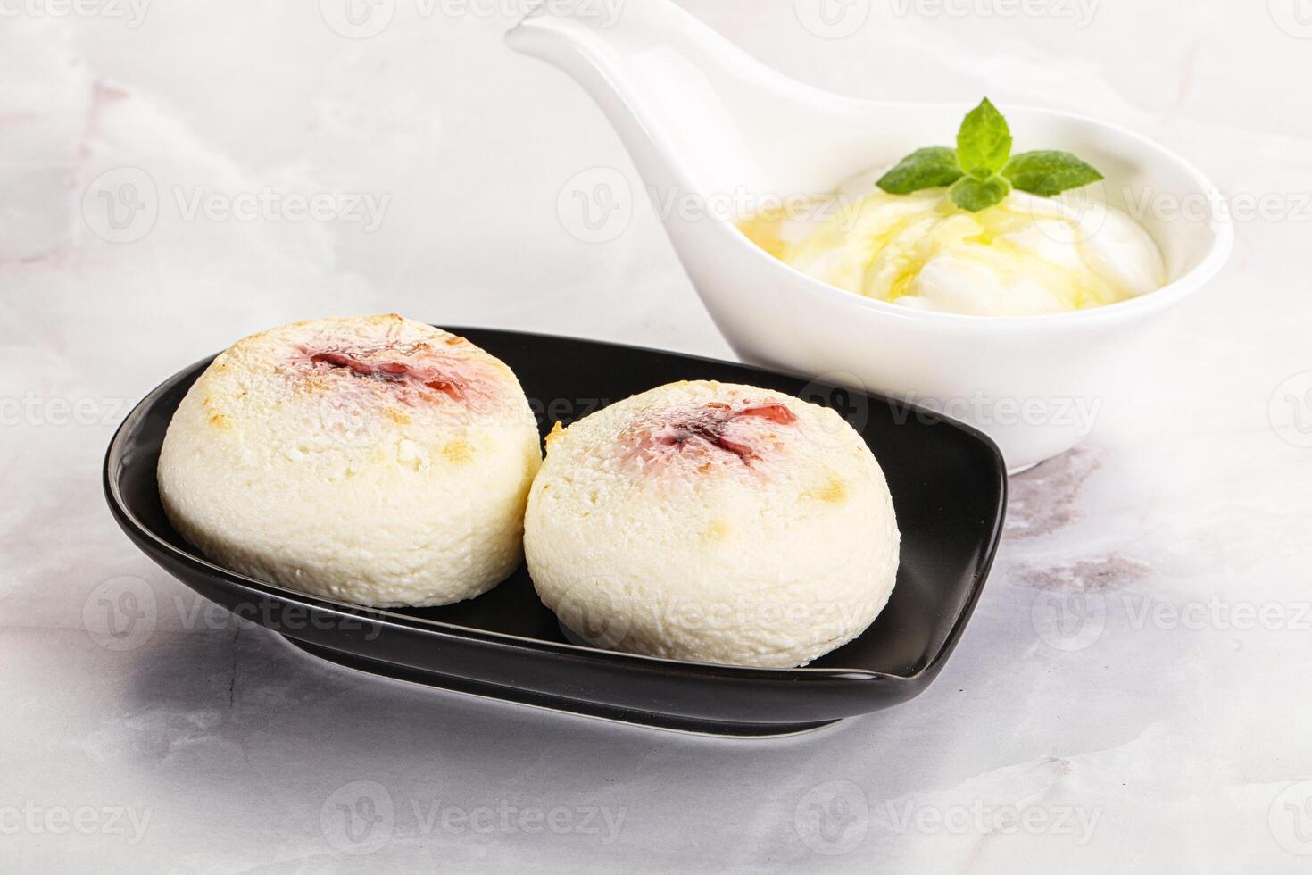 Curd pancakes with sour cream photo