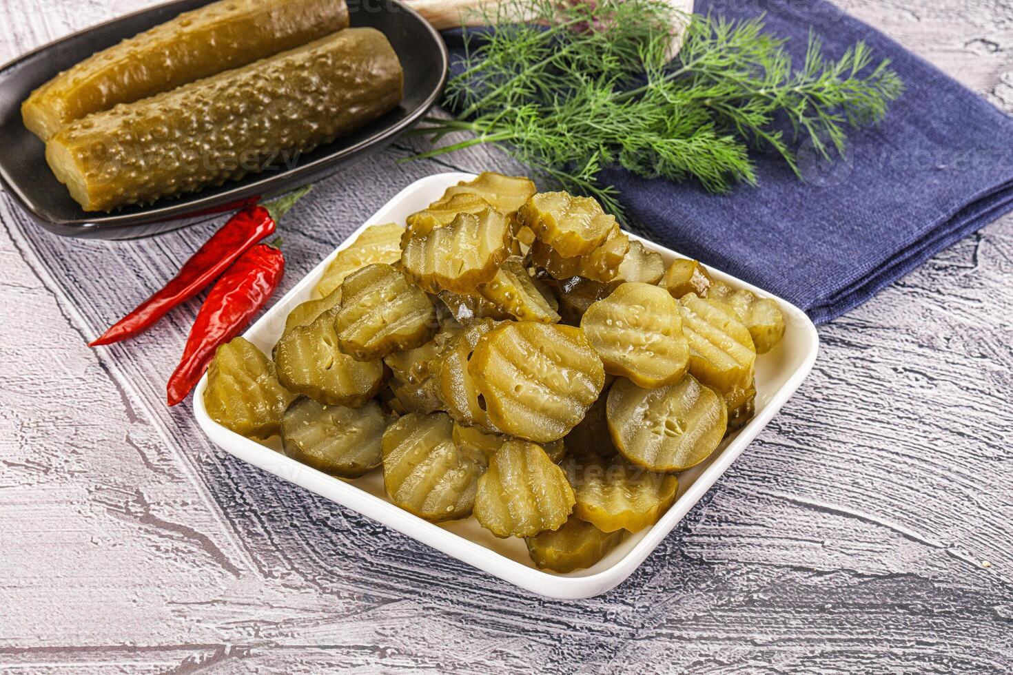 Sliced marinated cucumbers in the bowl photo