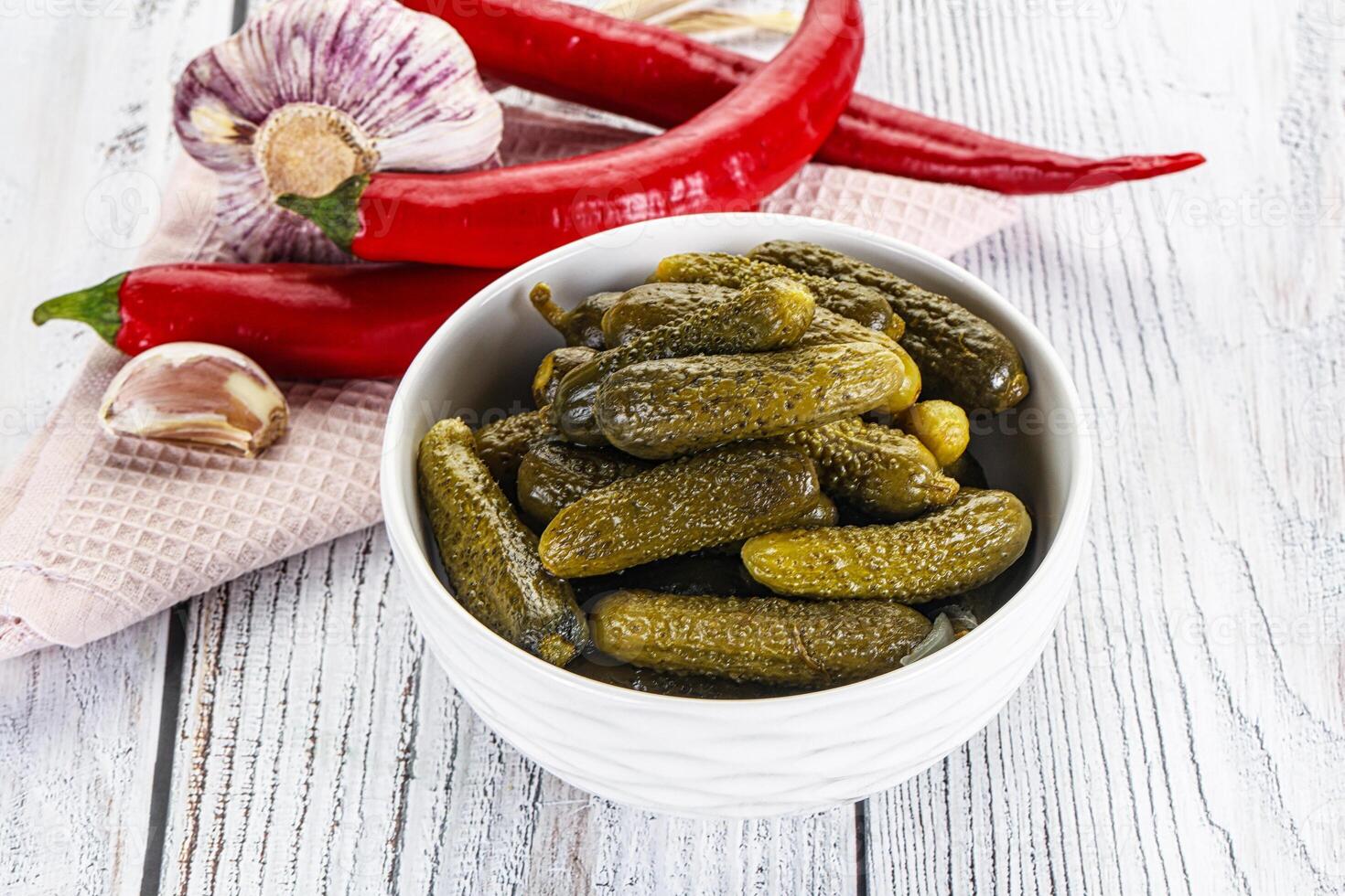 Marinated small cucumbers in the bowl photo