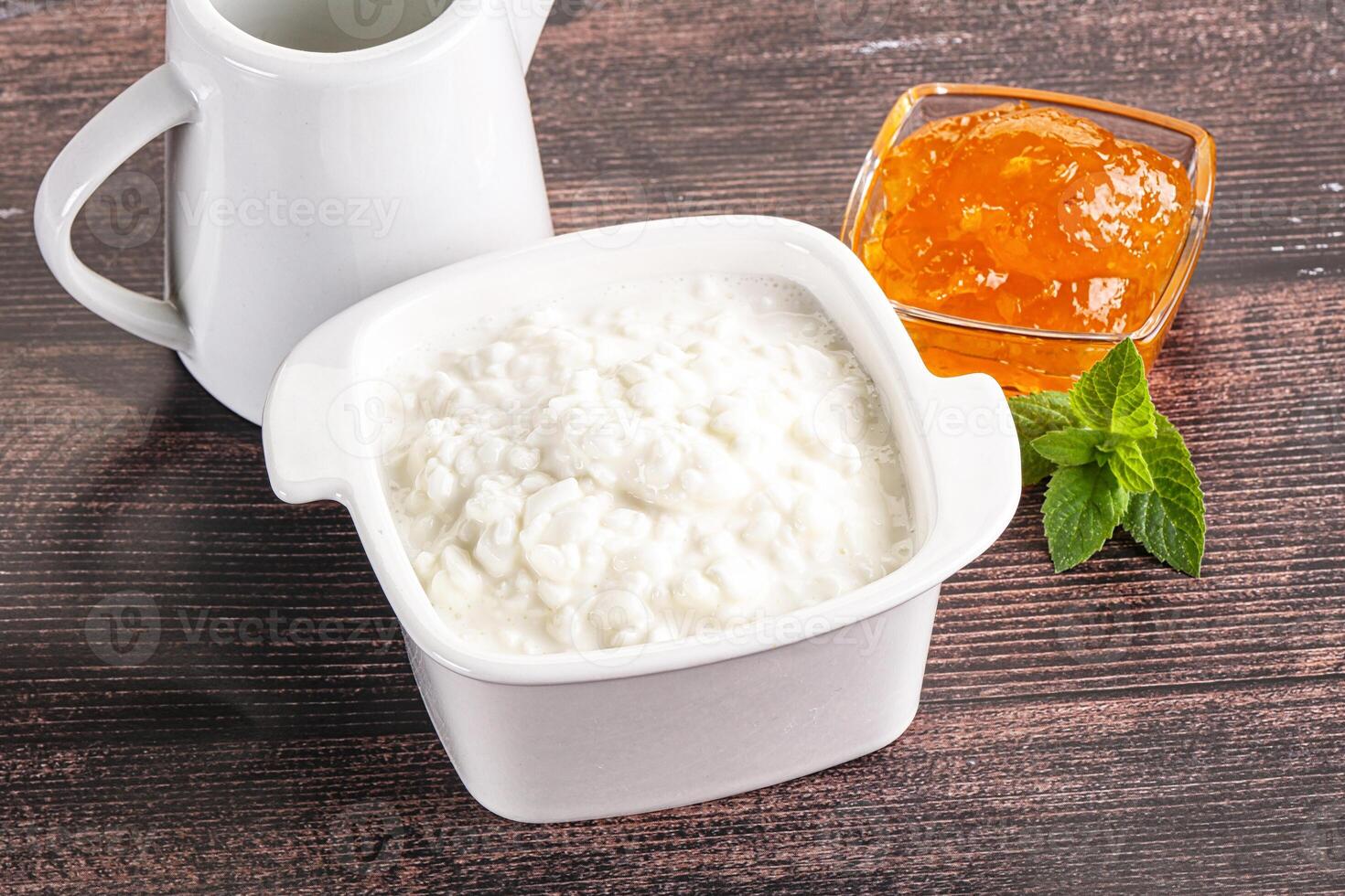 Grain curd with cream and jam photo