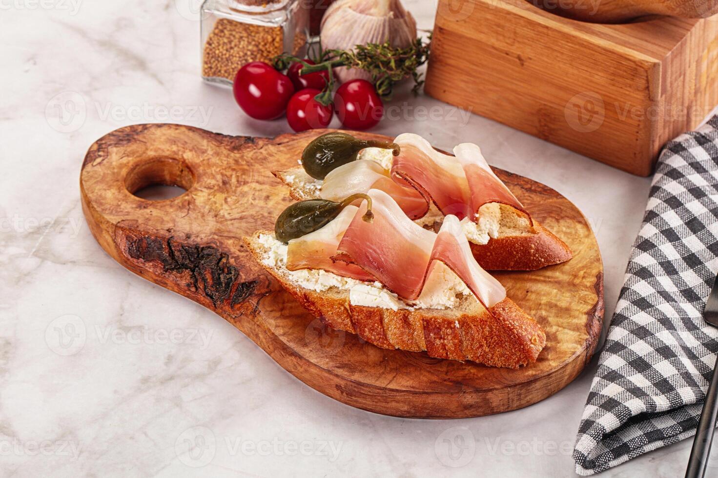 Bruschetta with jamon and caper berries photo