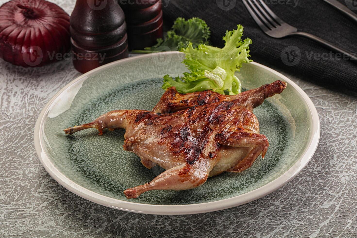 Grilled quail in the plate photo