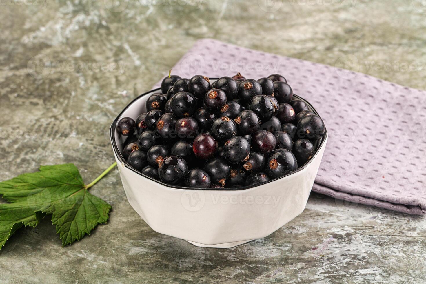 Ripe black currant in the bowl photo