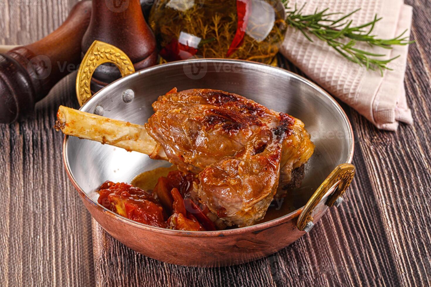 Baked lamb shank with vegetables photo