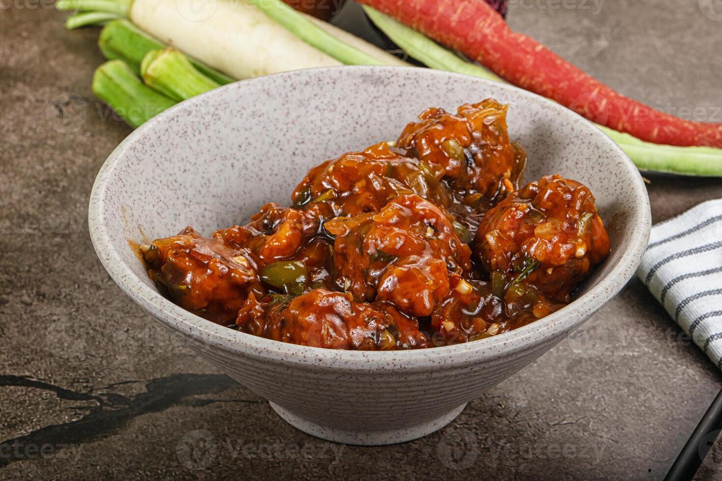 Manchurian chicken with sauce and spices photo