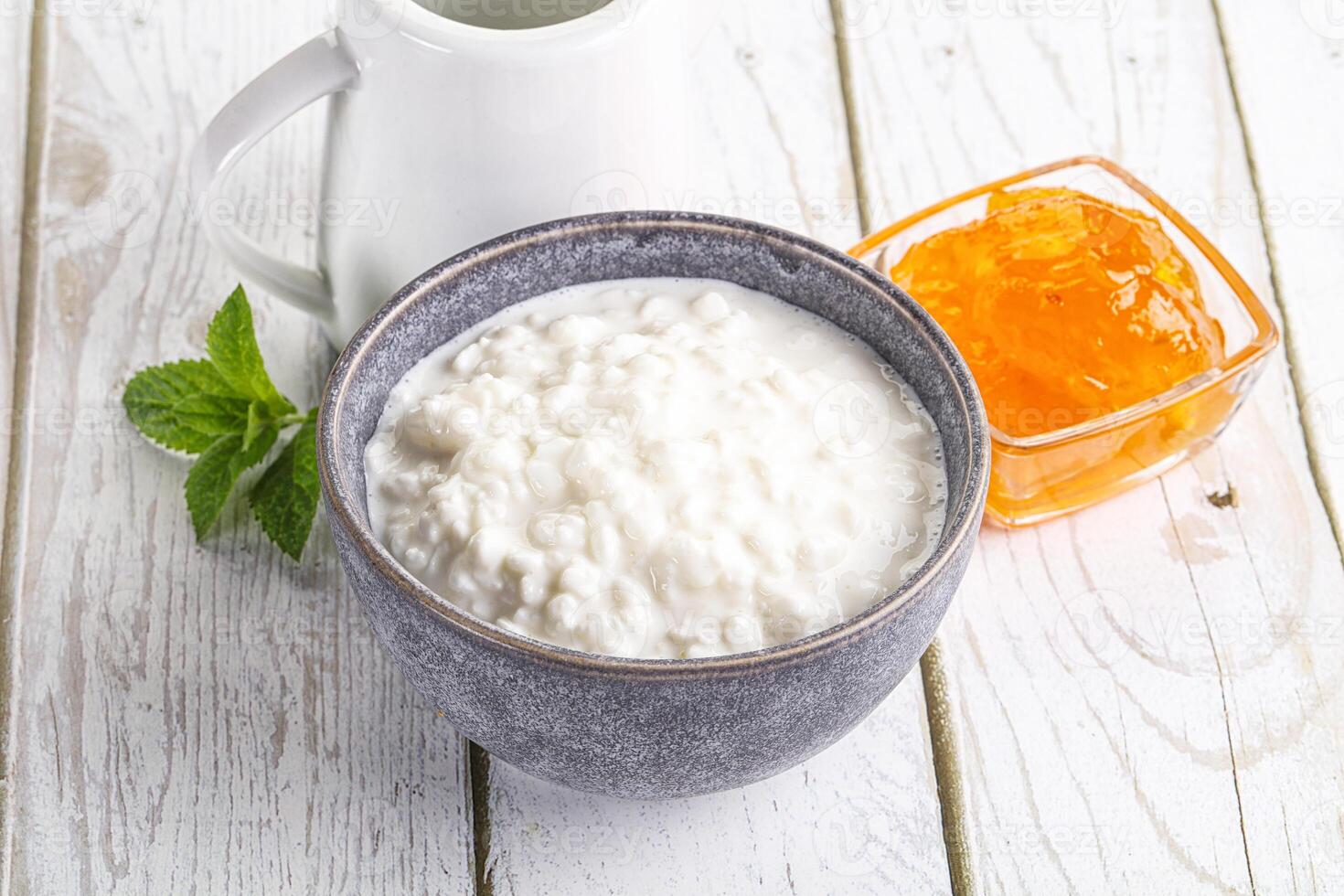 Grain curd with cream and jam photo
