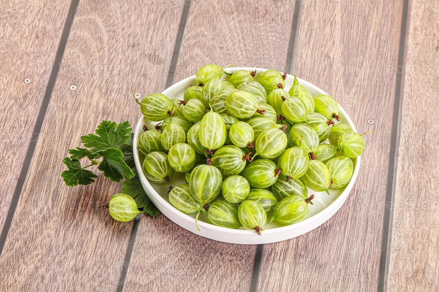 Sweet ripe gooseberries in the bowl photo