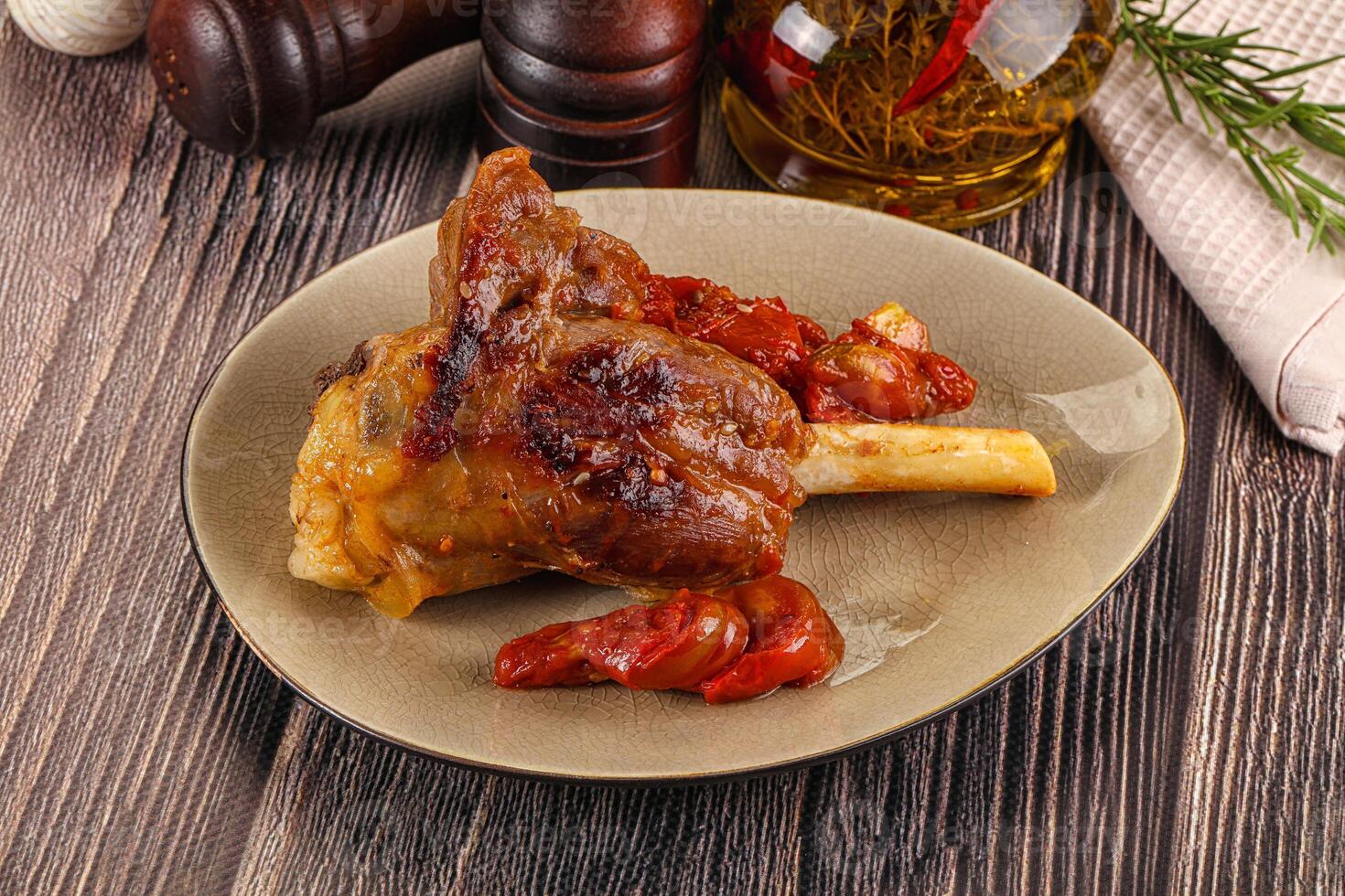 Baked lamb shank with vegetables photo