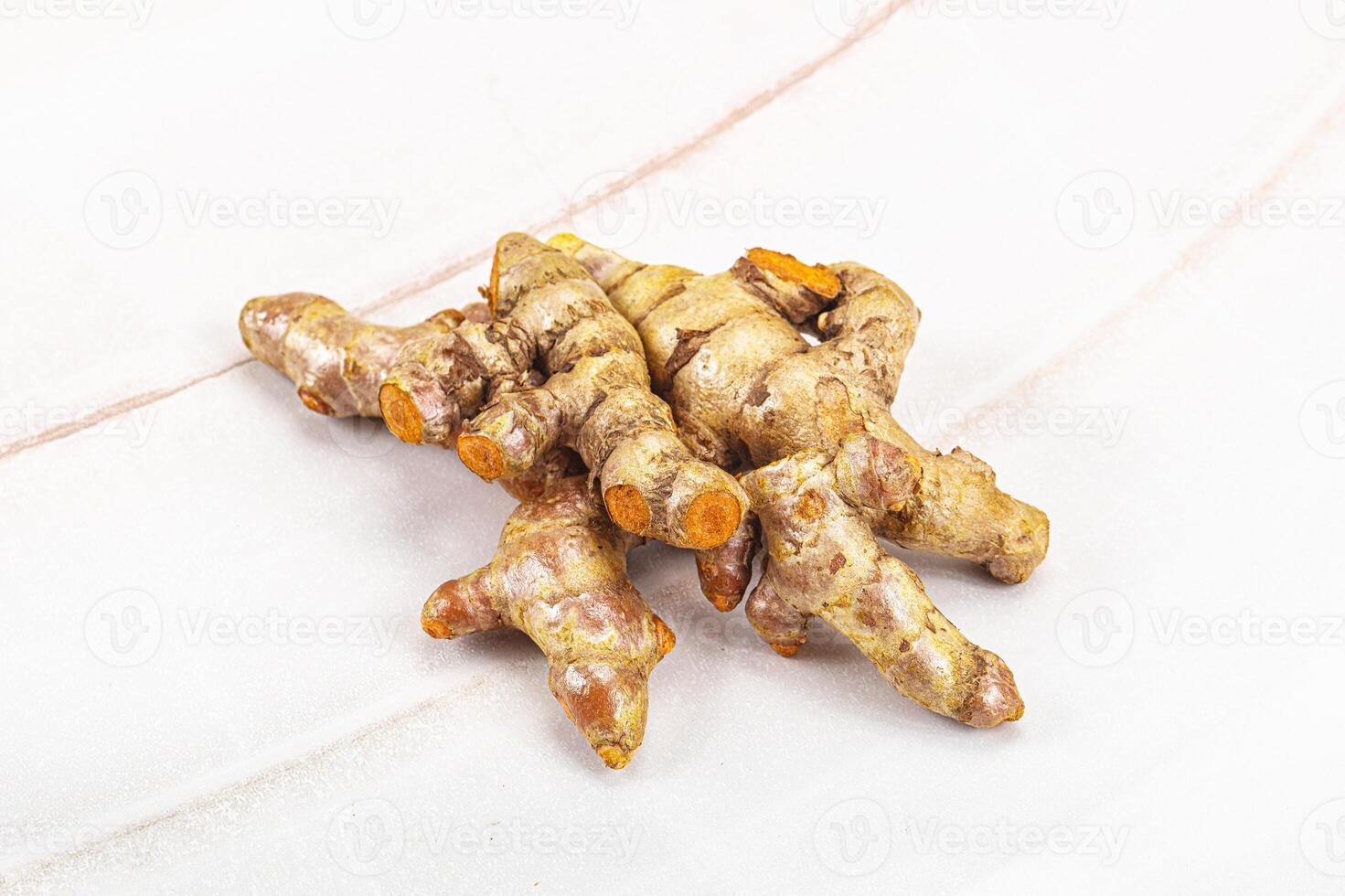 Fresh young Tumeric root heap photo