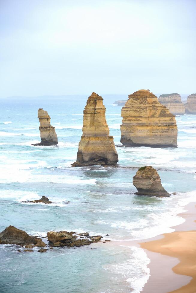 View of the 12 Apostles in cloudy day, Erosion of the mainland coast's limestone cliffs on The Great Ocean Road is an Australian National Heritage-listed at south-eastern coast of Victoria, Australia photo