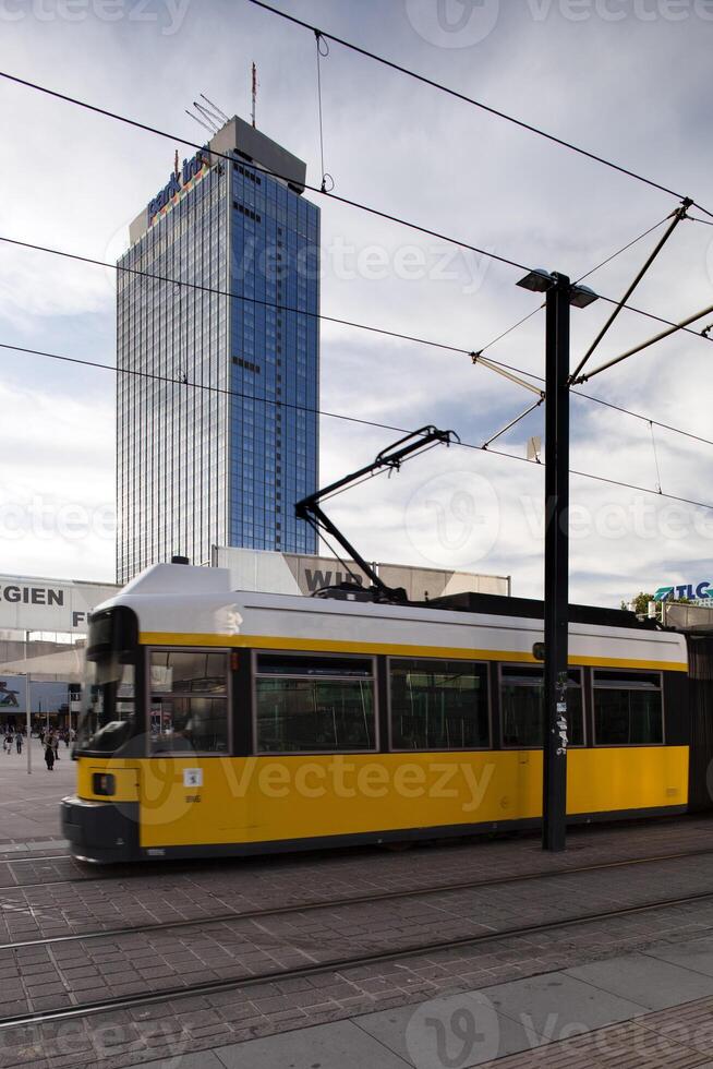 Tram Passing by Park Inn Hotel Against a Cloudy Sky in Berlin Mitte photo