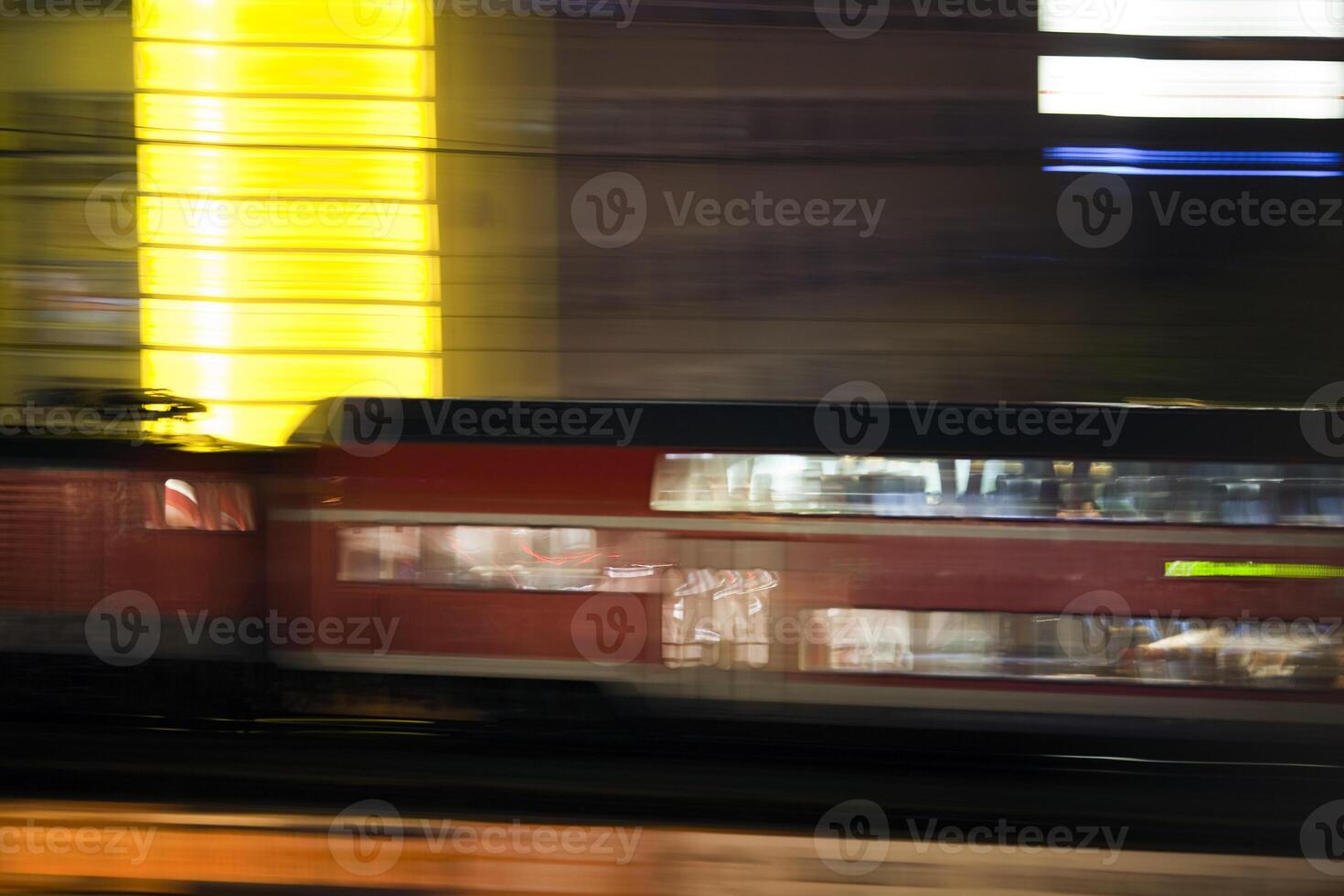 Panning Shot of a Train Speeding Through Berlin at Night photo