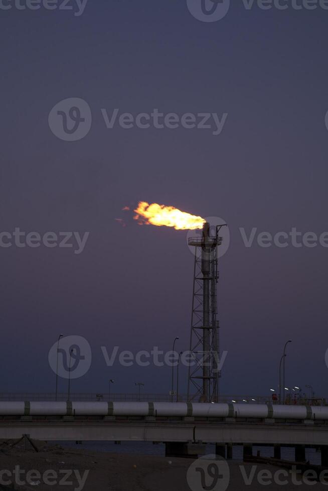 Coastal Regasification Plant Flare at Dusk in Huelva, Andalusia photo