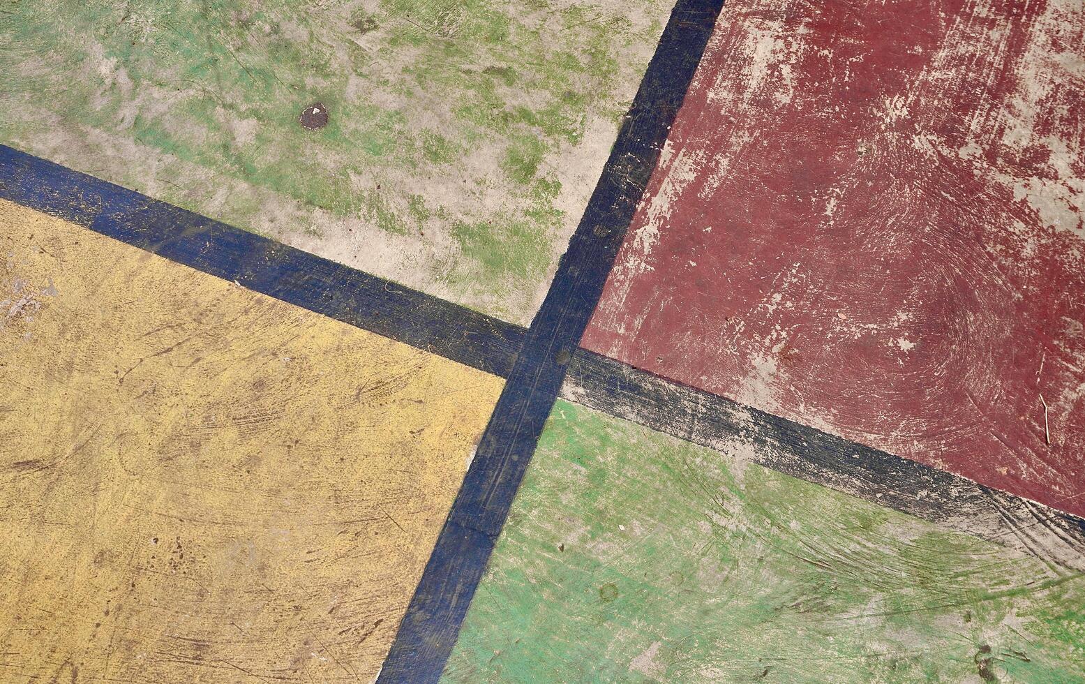 Old and aged scratched red, yellow, and green colored concrete ground flooring texture isolated on horizontal ratio background. photo