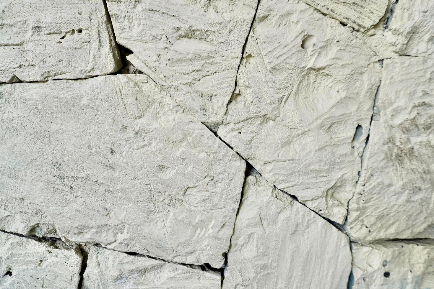 Abstract white stone wall texture with irregular shapes isolated on horizontal full frame background. photo