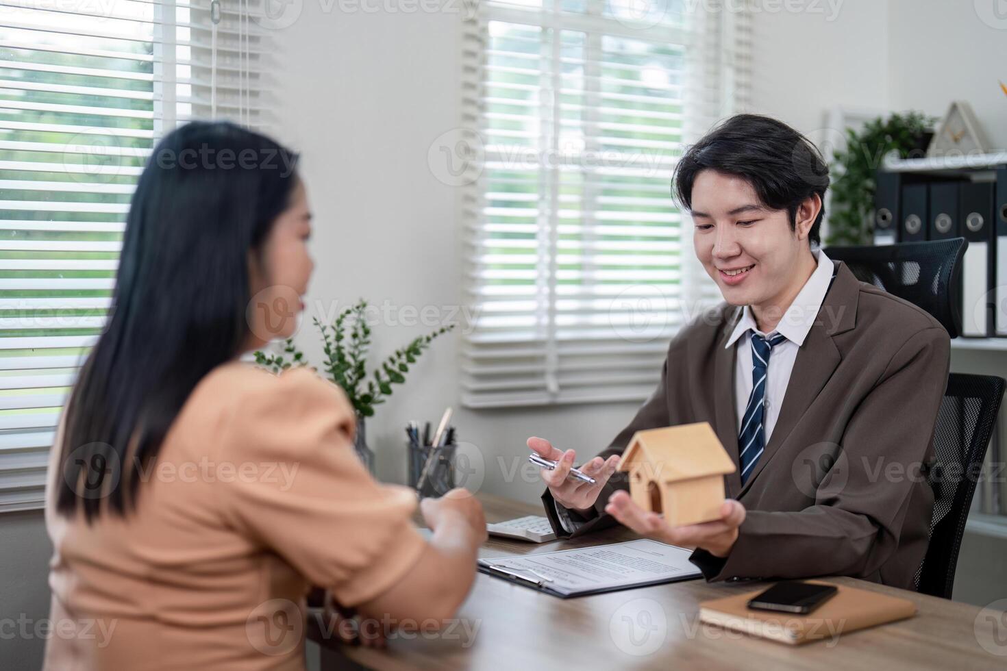 Young Realtor Presenting Property Options with Enthusiasm photo