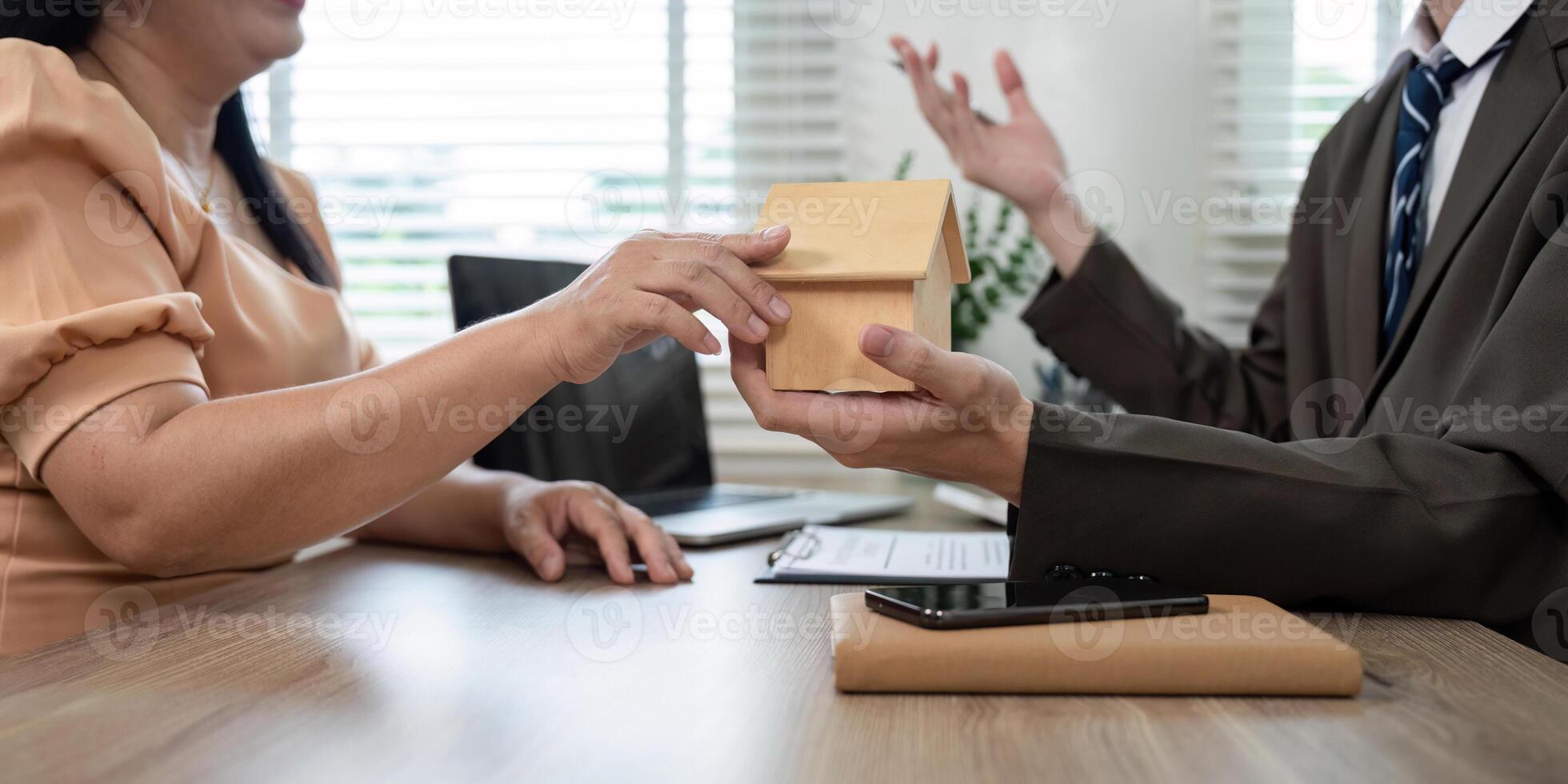 Real Estate Negotiation. Transferring Property Model During Client Meeting photo