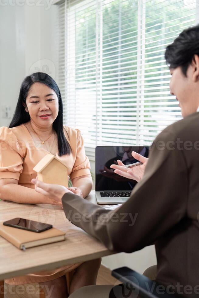 Real Estate Consultation. Client and Agent Discussing Property Details photo