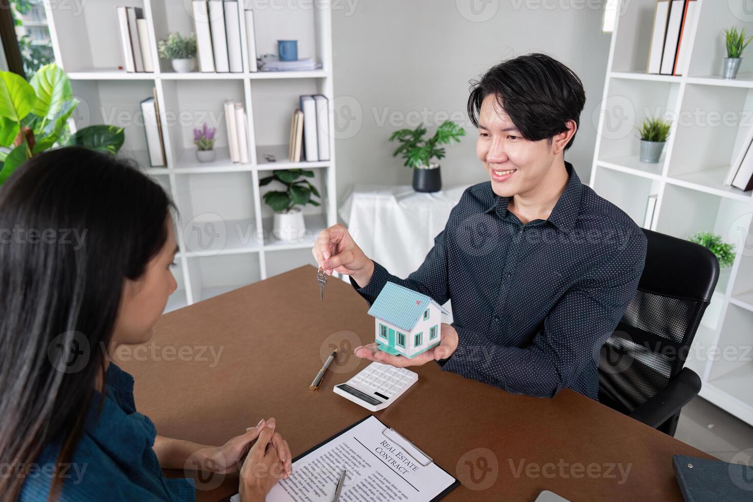 Real Estate Agent Finalizing Deal with Key Handover to Client photo