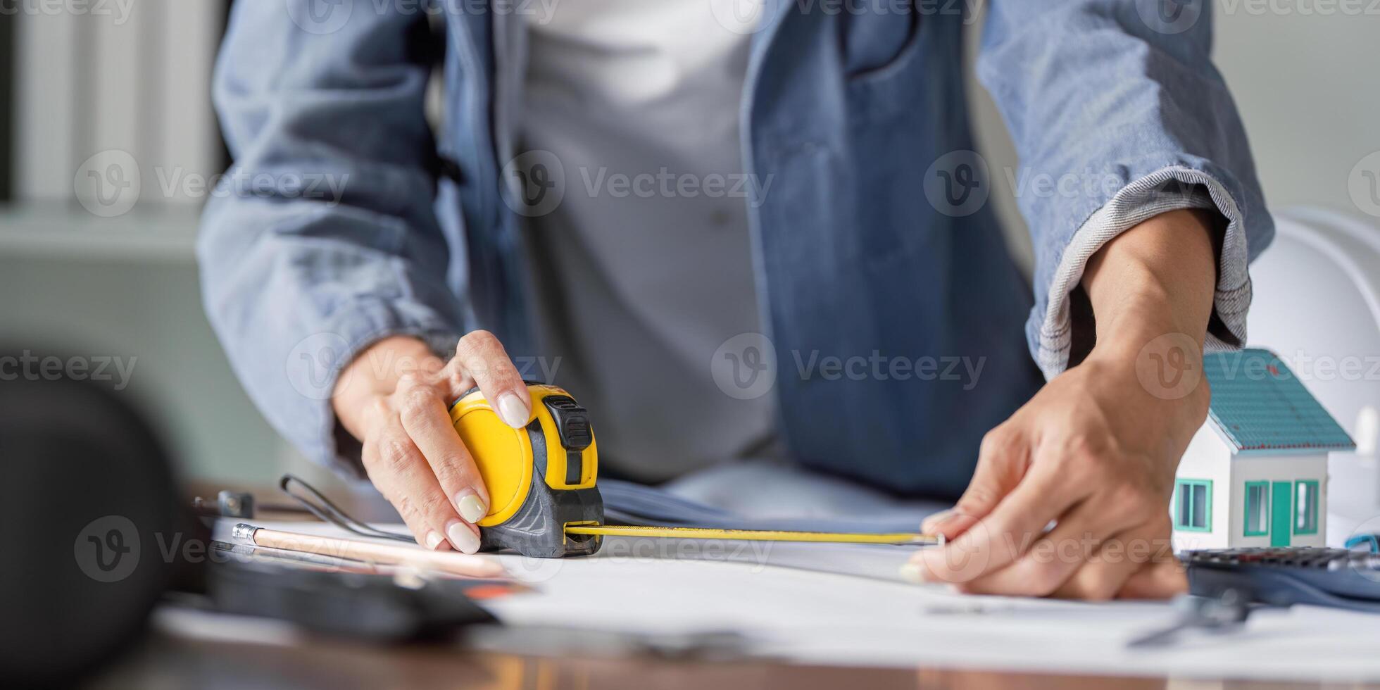 Civil Engineer Measuring Dimensions for Structural Accuracy in Building Projects photo
