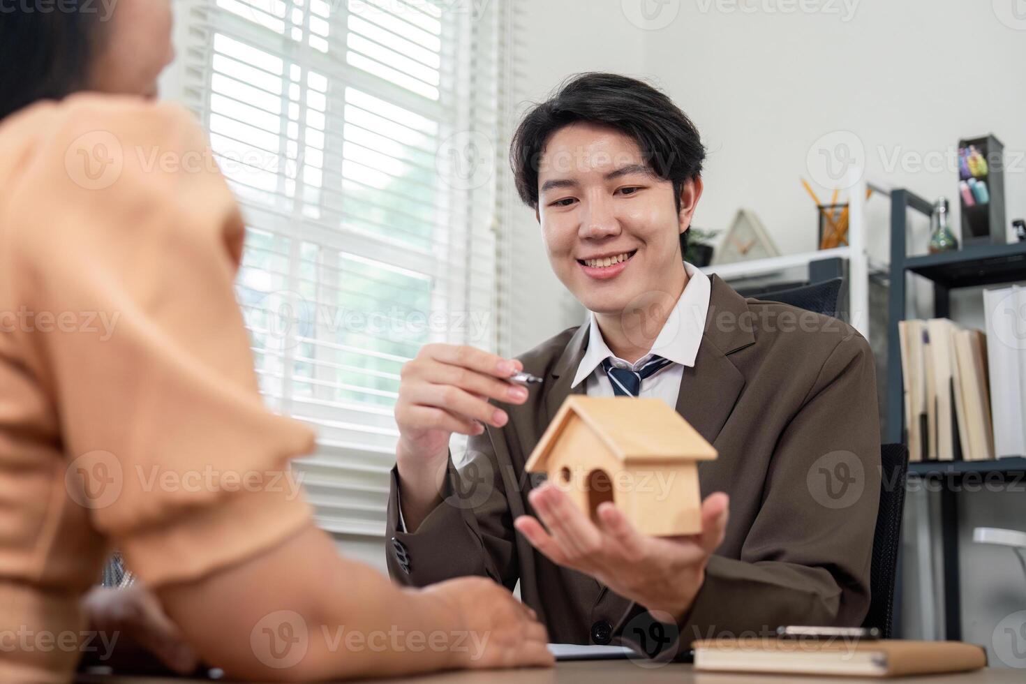 Real Estate Agent Presenting Home Ownership Opportunities to Client for Real Estate Investment Potential photo