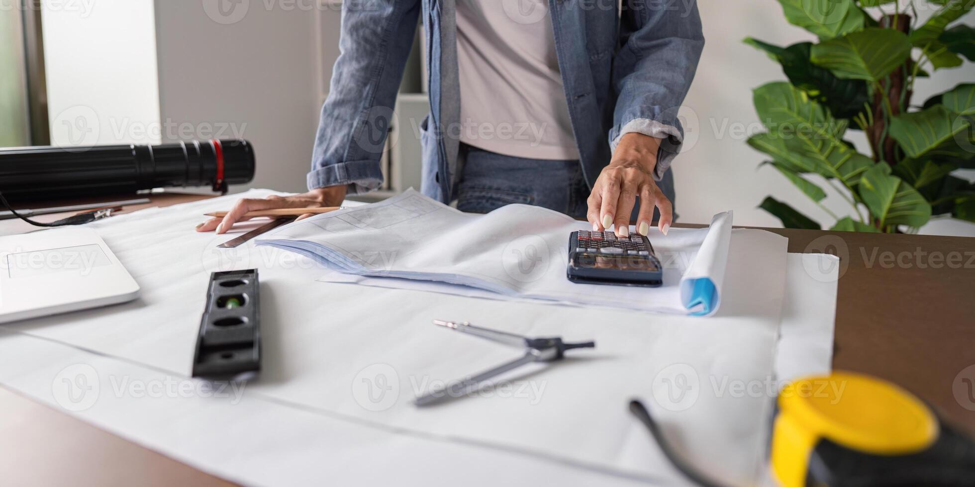 Architect Conducting Cost Calculations for Blueprint Planning in Architectural Projects photo