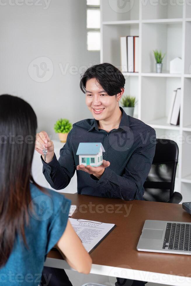 Real Estate Agent Presenting Keys to New Homebuyer photo