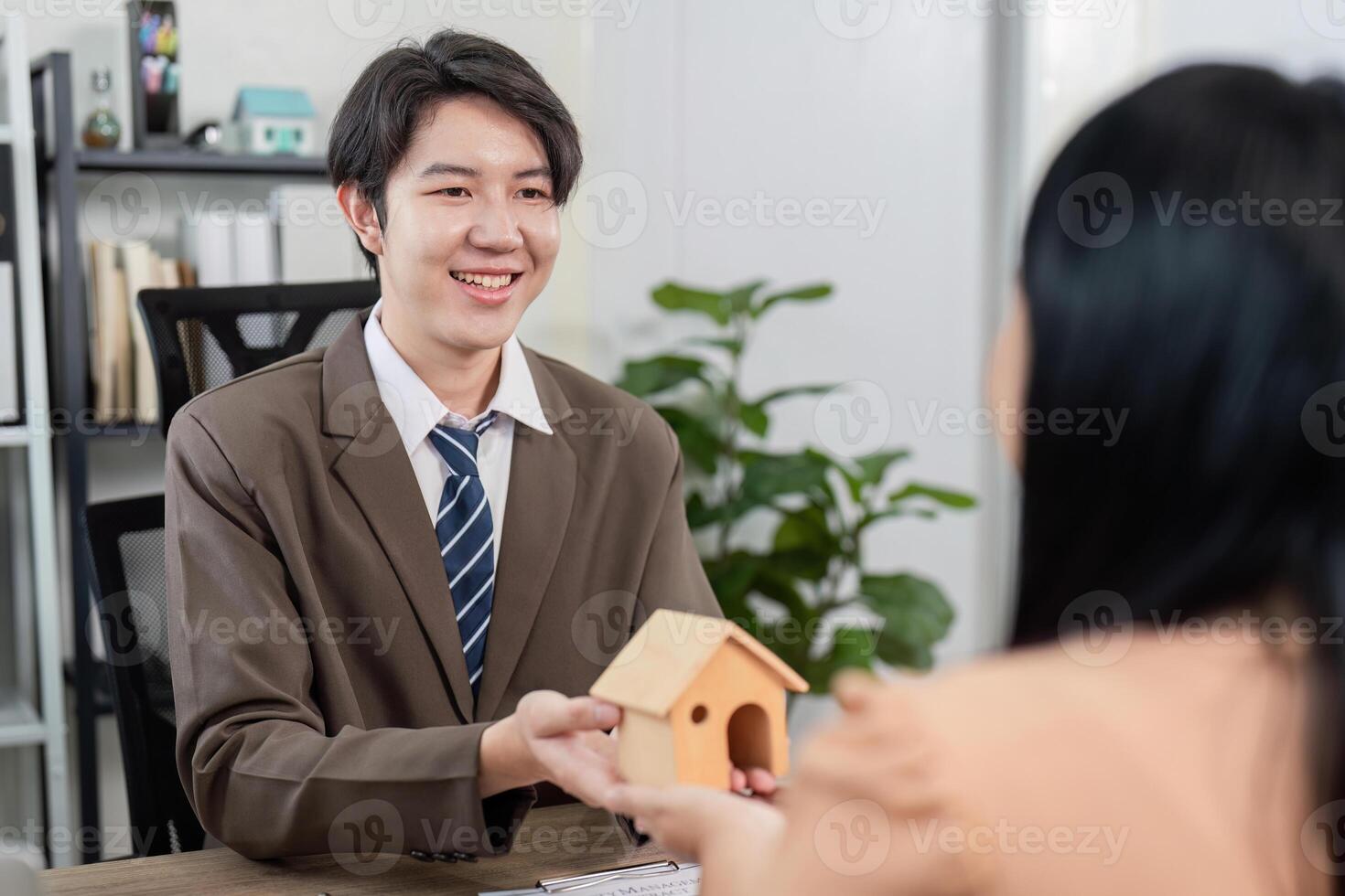 Real Estate Agent Facilitating Property Sale Discussion with Client for Home Ownership Goals photo