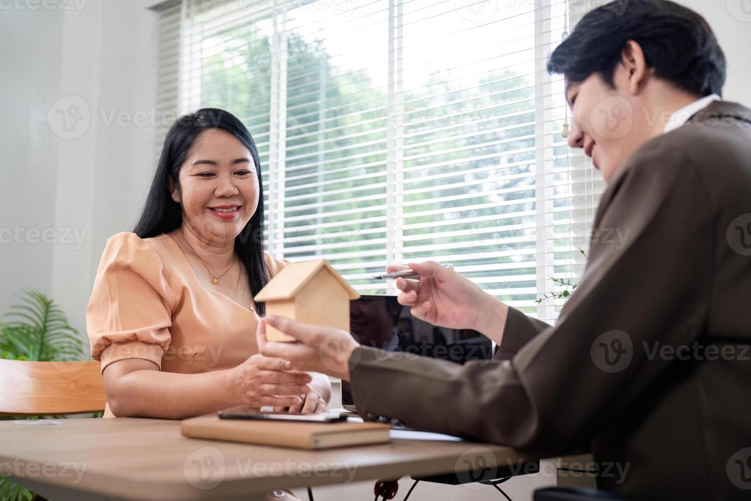 Client Deliberating Property Acquisition with Real Estate Agent photo