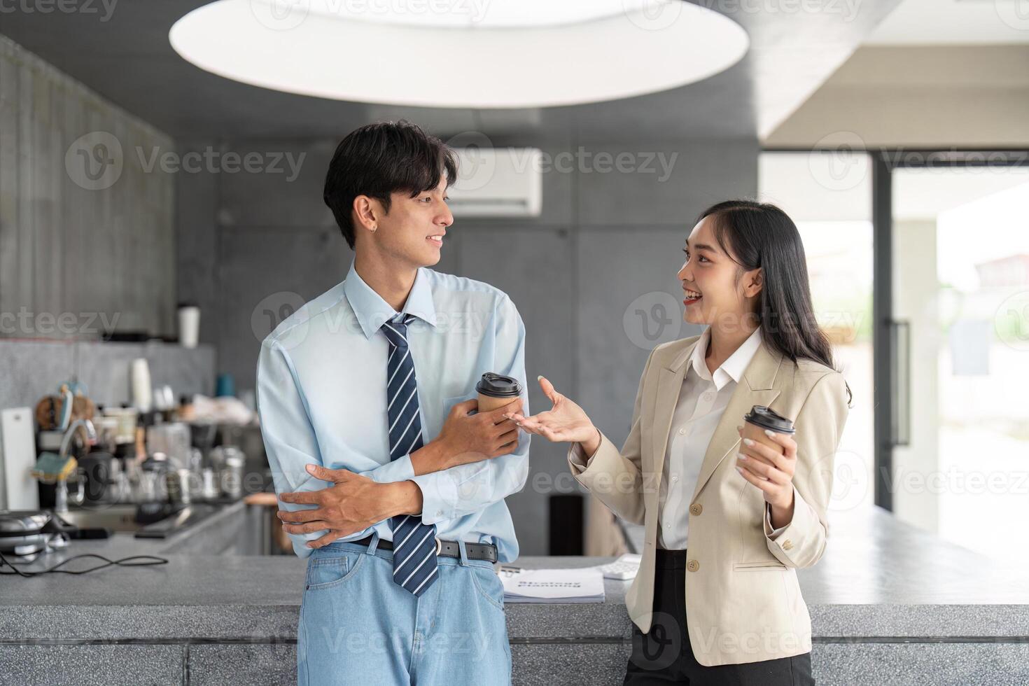 Colleagues engaging in lively conversation over coffee in cafe photo
