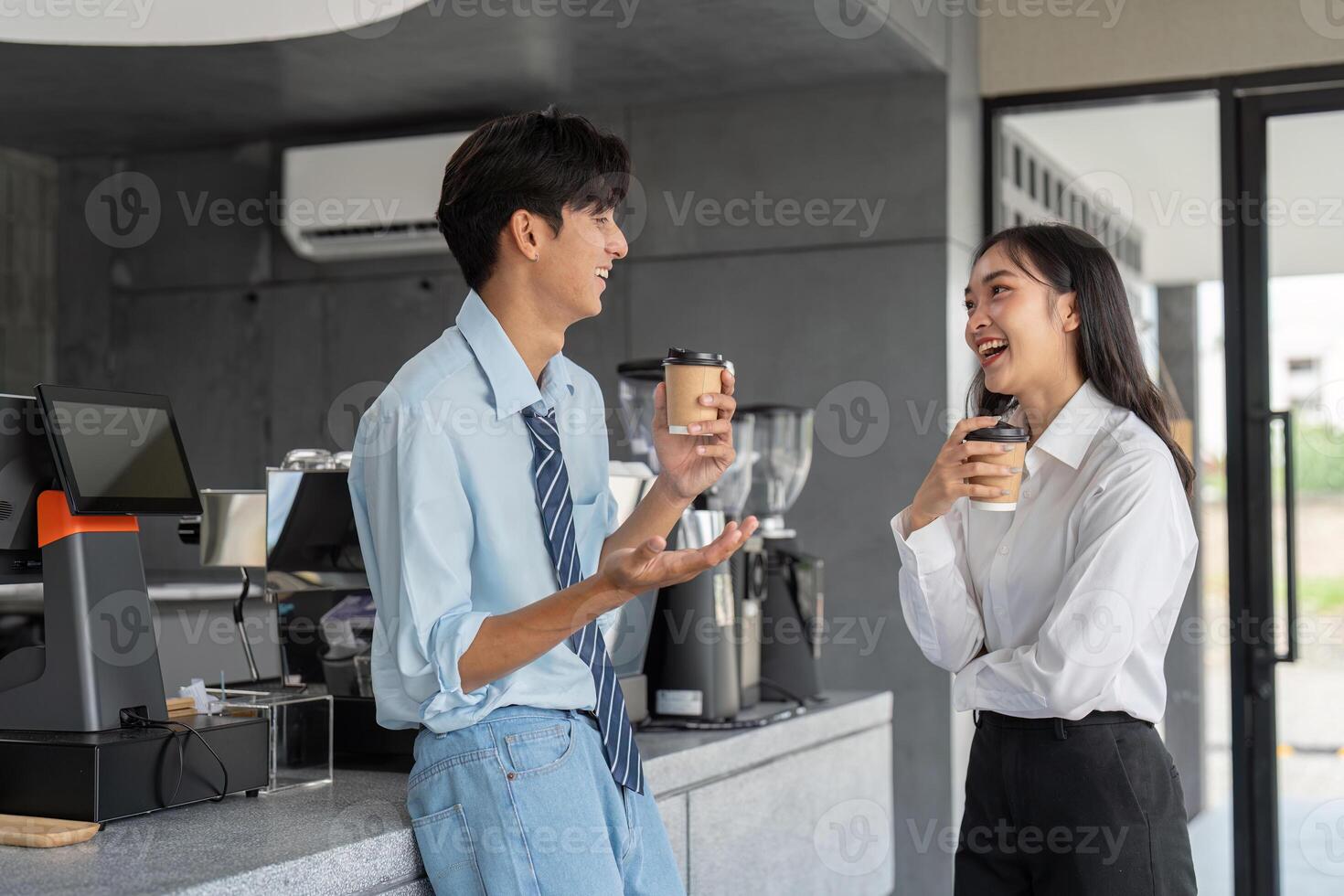 Colleagues enjoying a coffee break with laughter in cafe photo