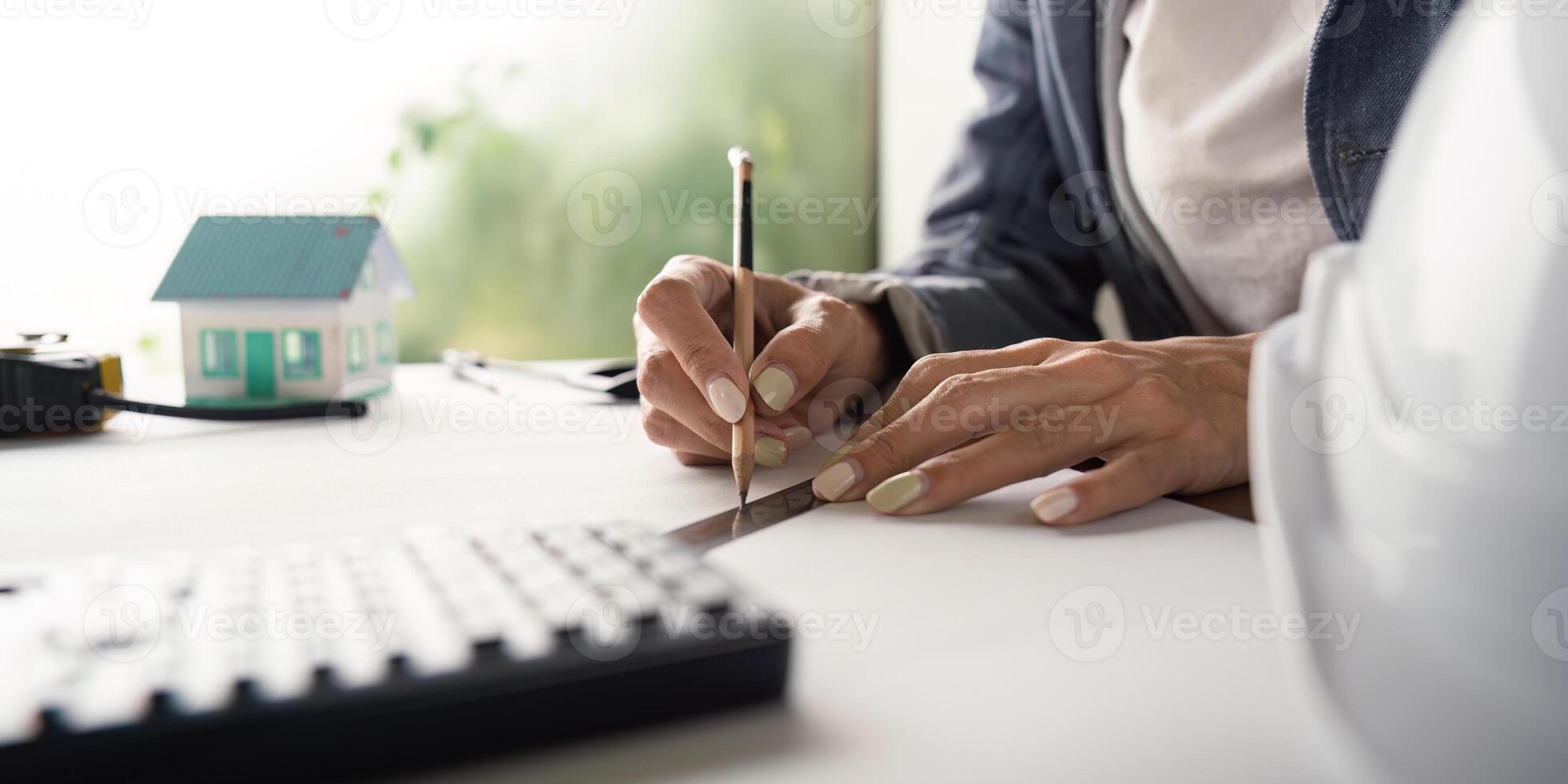 Close up of engineer drafting with pencil and ruler in office photo