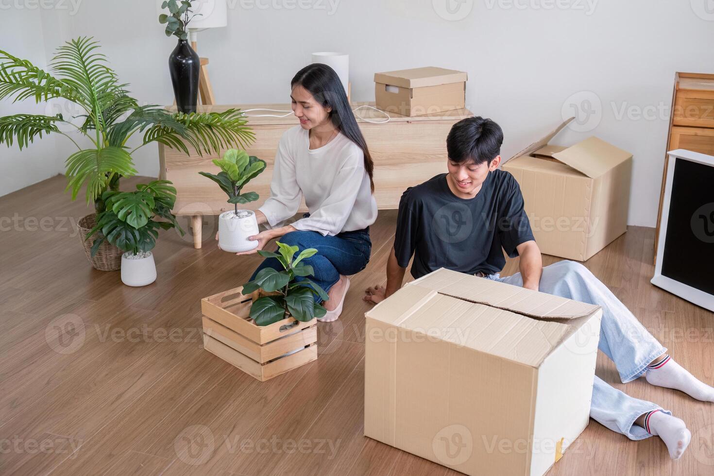 Practical Home Setup Couple Arranging Plants and Boxes photo