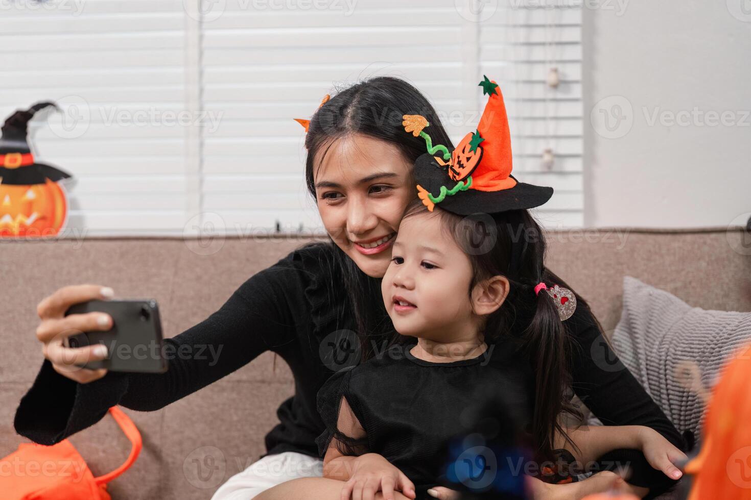 Mother and daughter taking a Halloween selfie at home photo