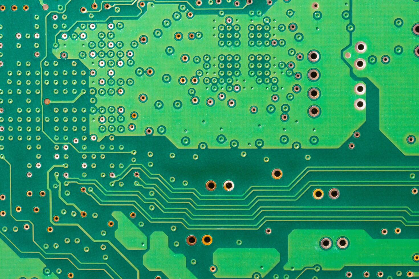 Close-up of a green printed circuit board with electronic components and chips photo
