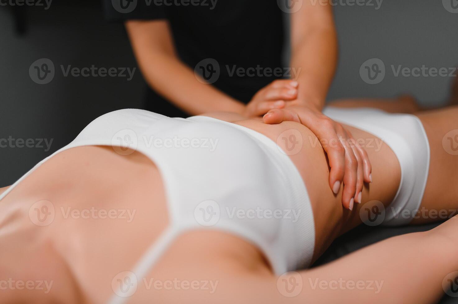 A woman receiving a belly massage at a beauty salon photo